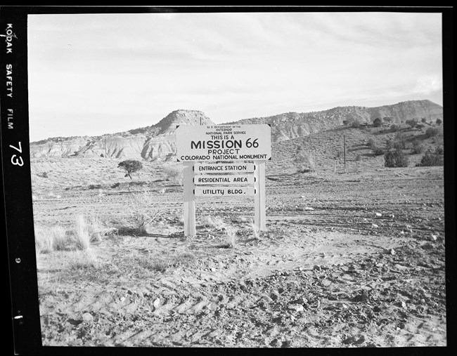 White sign with Black Text - This is a Mission 66 Project Colorado National Monument