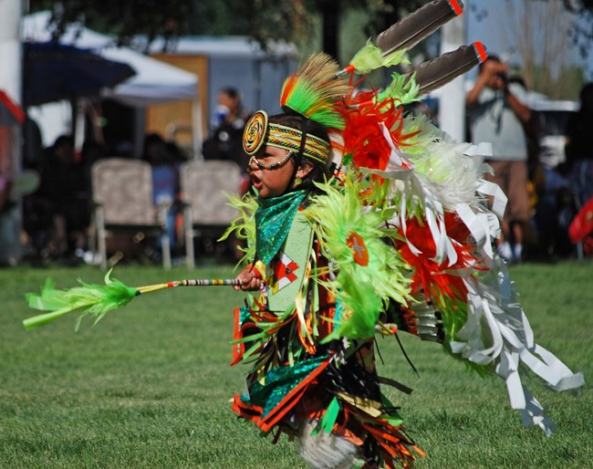 A Ute boy dancing in traditional clothing