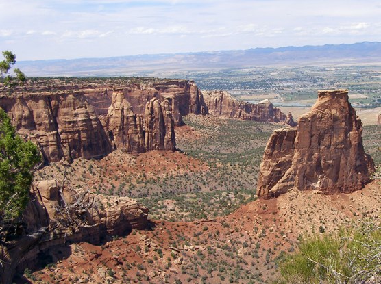 View looking out over red rock formations to the horizon