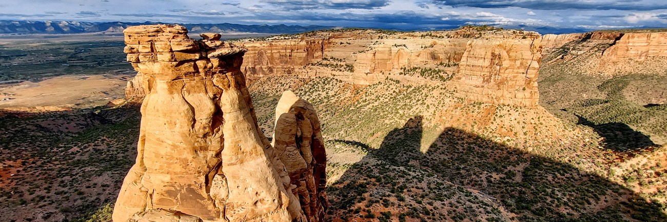 red orange sandstone tower, known as Organ Pipe, seen at the end of Ottos Trail