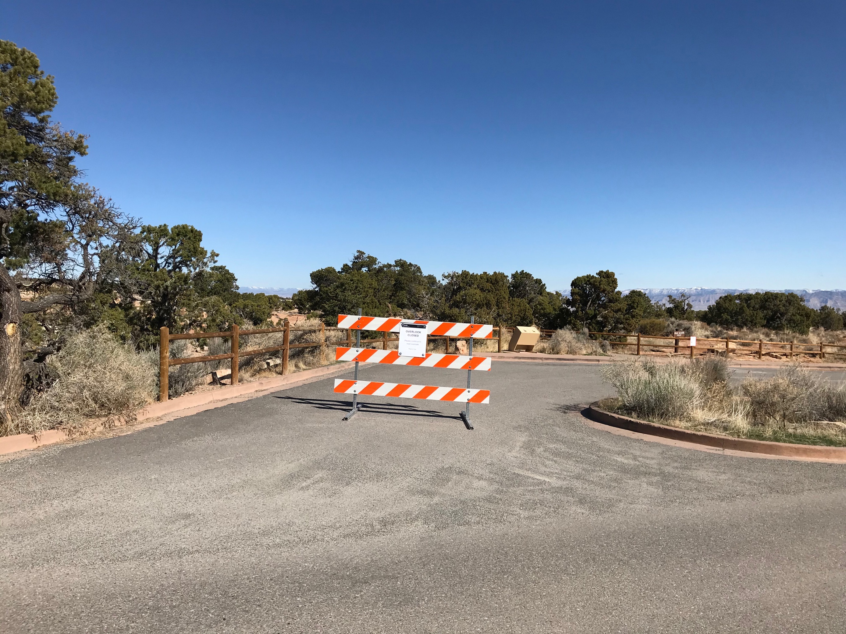 Highway barricade across entrance to paved overlook parking area