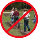 Children walking on the brick foundations of Jamestown displayed as a stop sign
