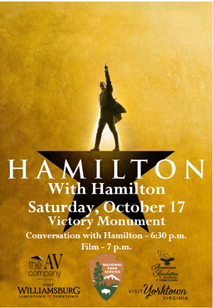 Actor who plays Hamilton standing with hand in air and legs spread apart