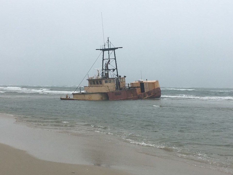 Photo of grounded vessel in water.