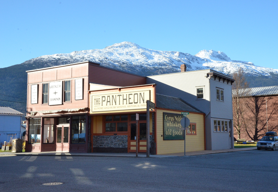 Modern photo of group of brightly colored buildings with mountain background