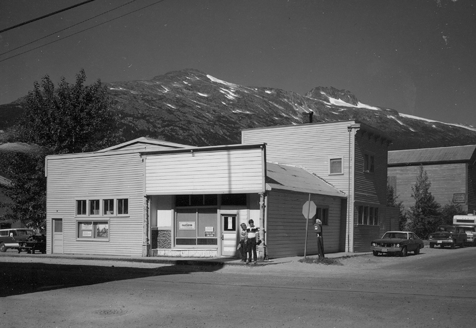 Modern photo of group of brightly colored buildings with mountain background