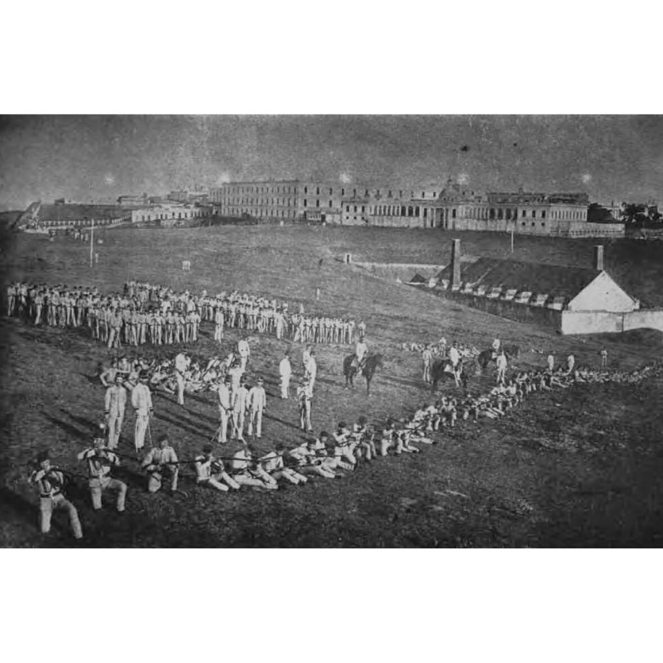 Groups of soldiers gathered on a large grassy field