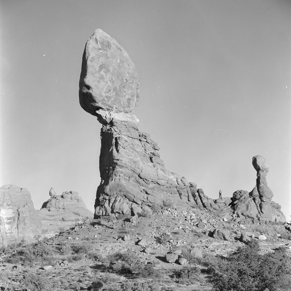 A massive rock perched on a smaller pedestal. A smaller pinnacle stands to the right.