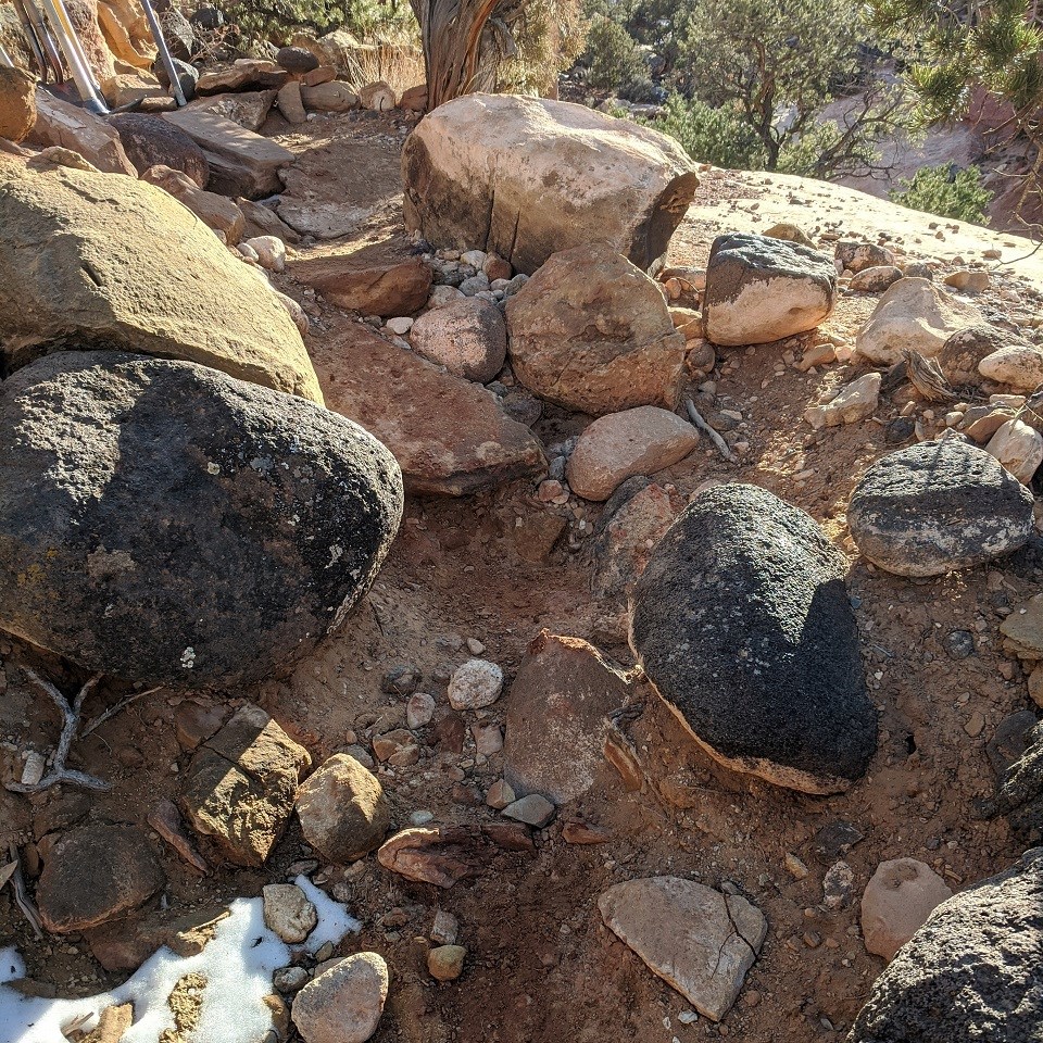 rocks and boulders of various sizes obscure the trail