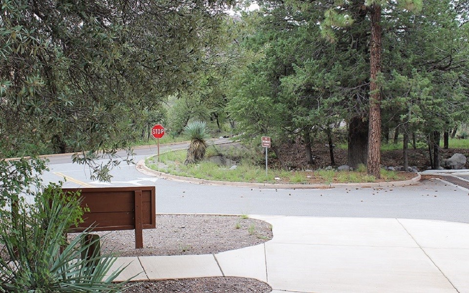 Flooded parking lot with brown flowing water.