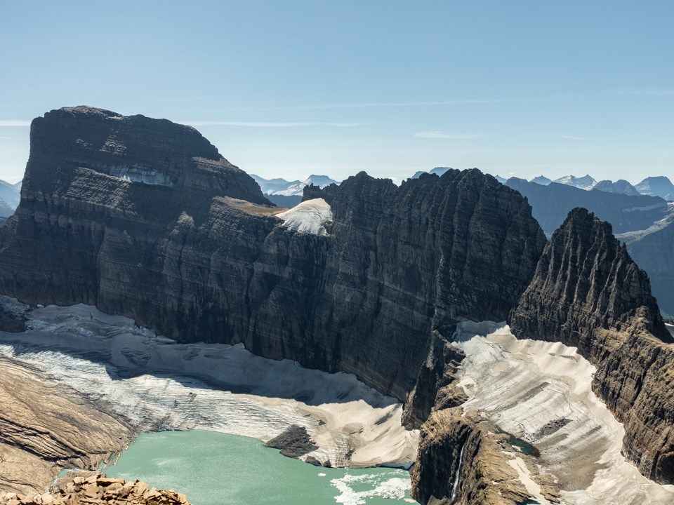 A mountainous glacier below a rocky mountain.