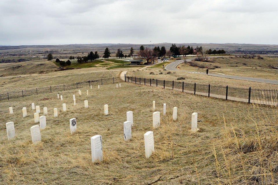 Looking down at Custer's marker. Can see the Visitor Center in the background.