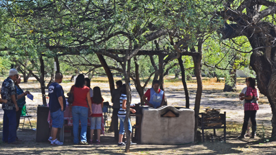 illustration of ramadas with smoke, figures, and low slung buildings