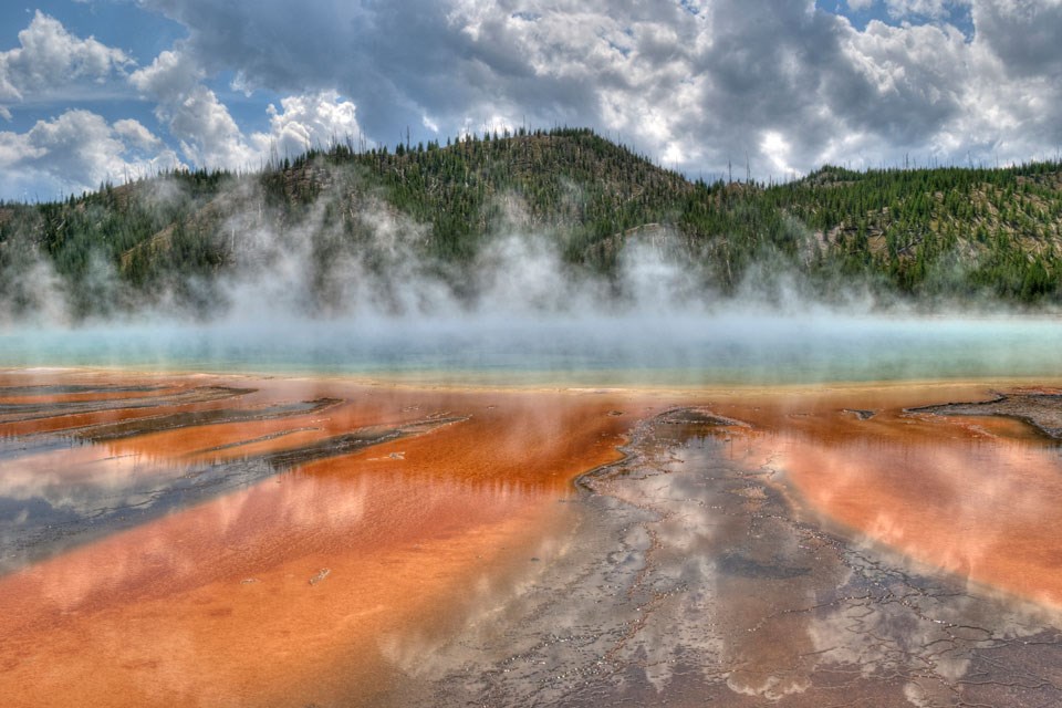 Hot blue water issues steam.