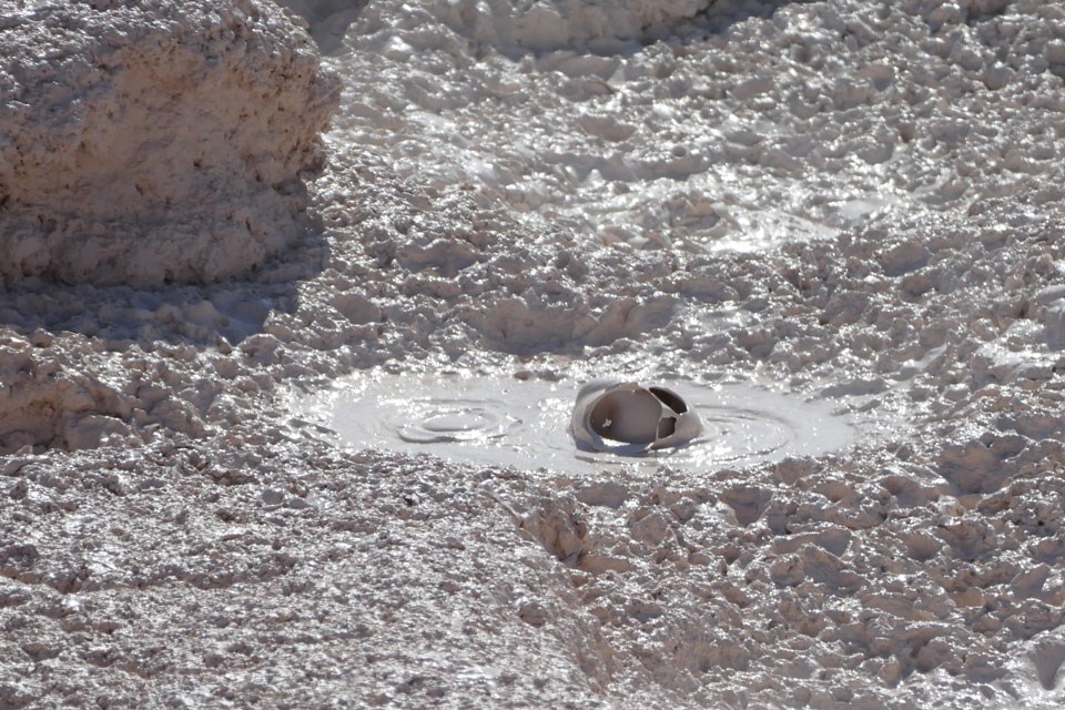 Steam rises from a cracked and contorted hole in the ground.