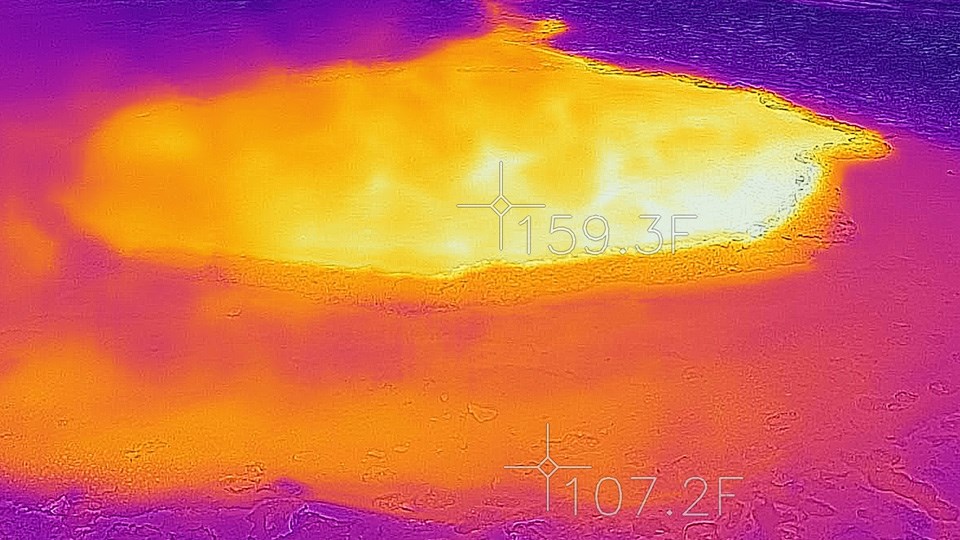 Infrared scene shows the hot water of the hot spring (in yellow) in contrast the the surrounding cool landscape (in blue)