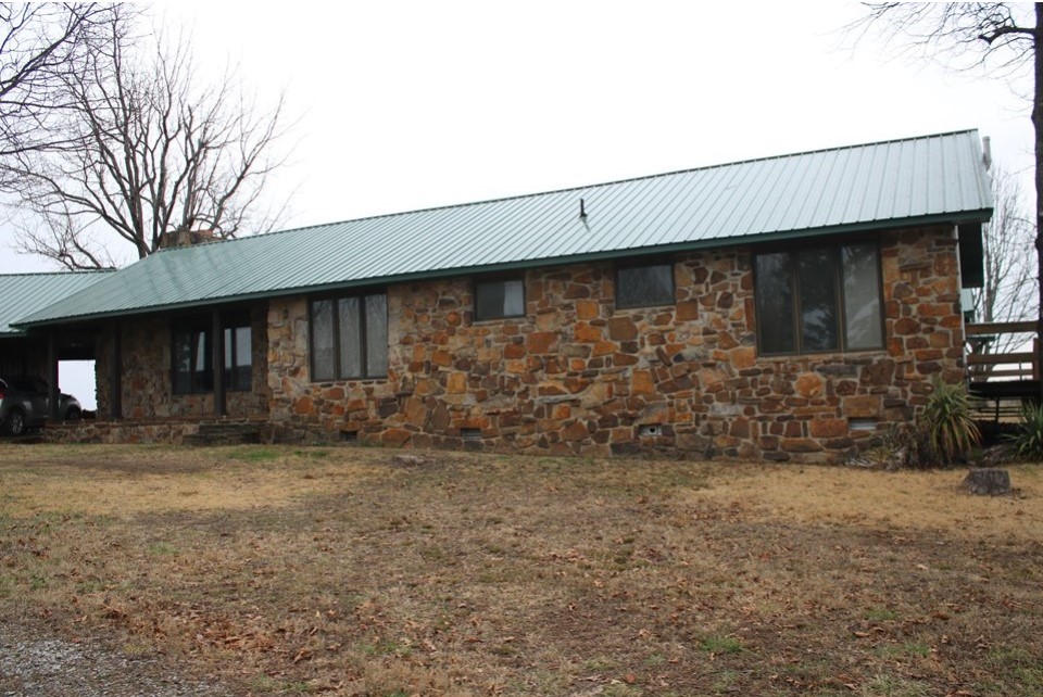 A tan house made of stone.