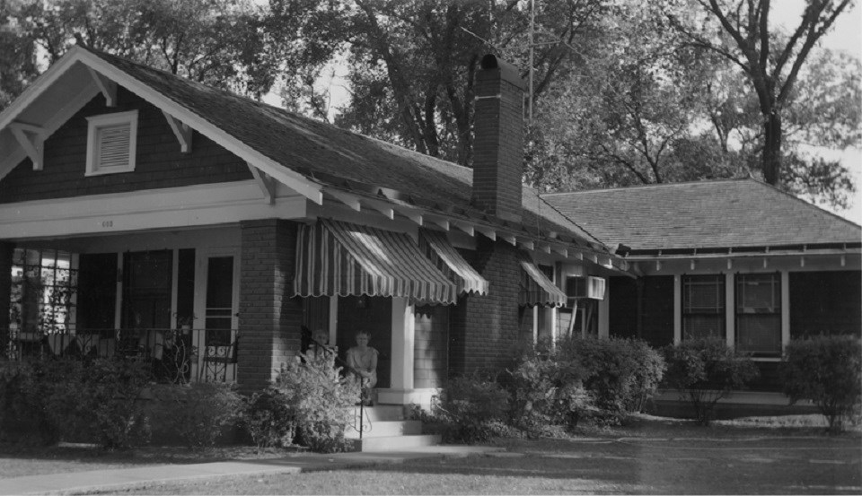 1910's bungalow-style house with two women posing