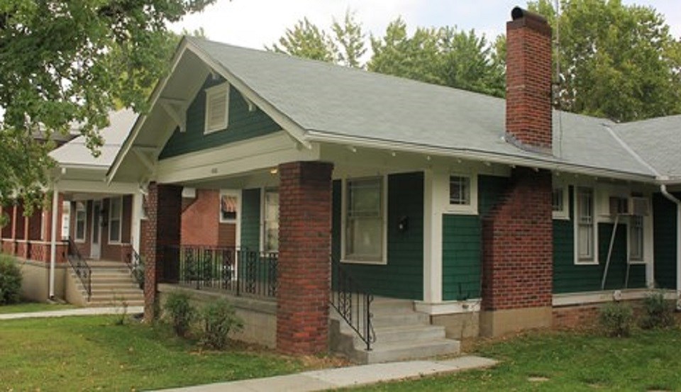 1910's bungalow-style house with two women posing