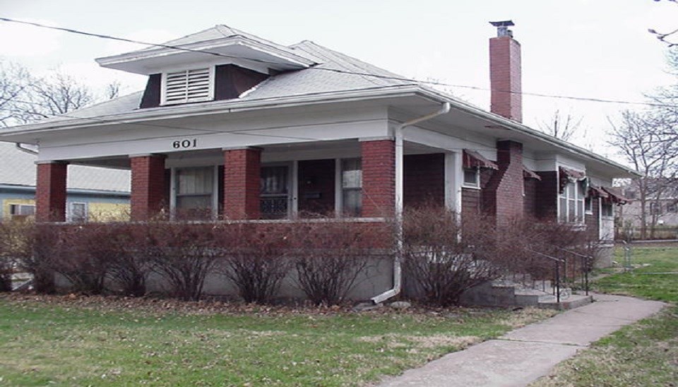 Brick bungalow-style house, Frank and Natalie Wallace posing