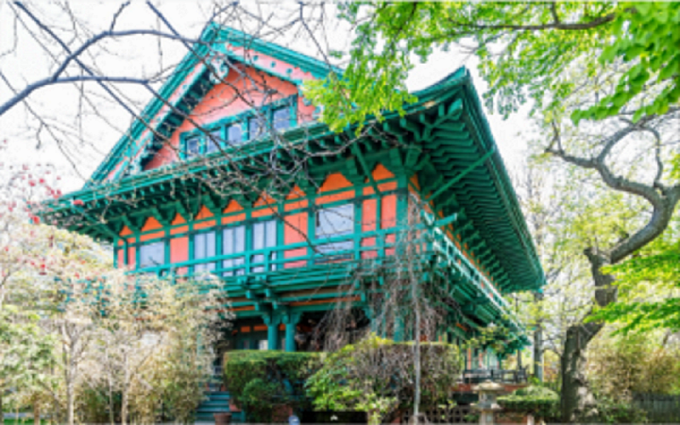 a house that is painted a orange color with bluish colored trim