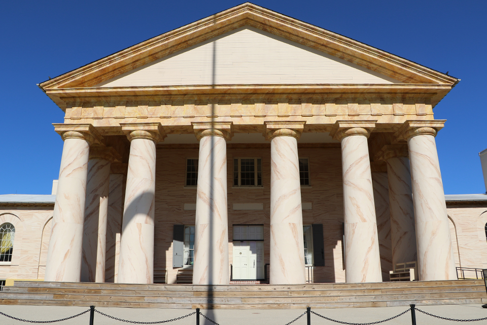 Front columns of Arlington with peeling paint.