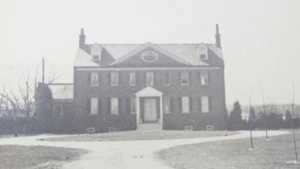 black and white photo of a brick manor
