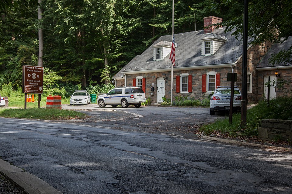 Potholes and patches on road near US Park Police Station in Rock Creek Park