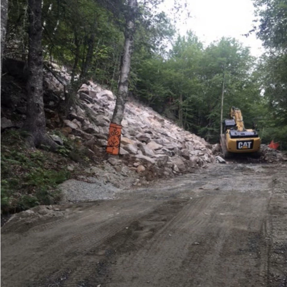 a heavy machine works along rough carriage road