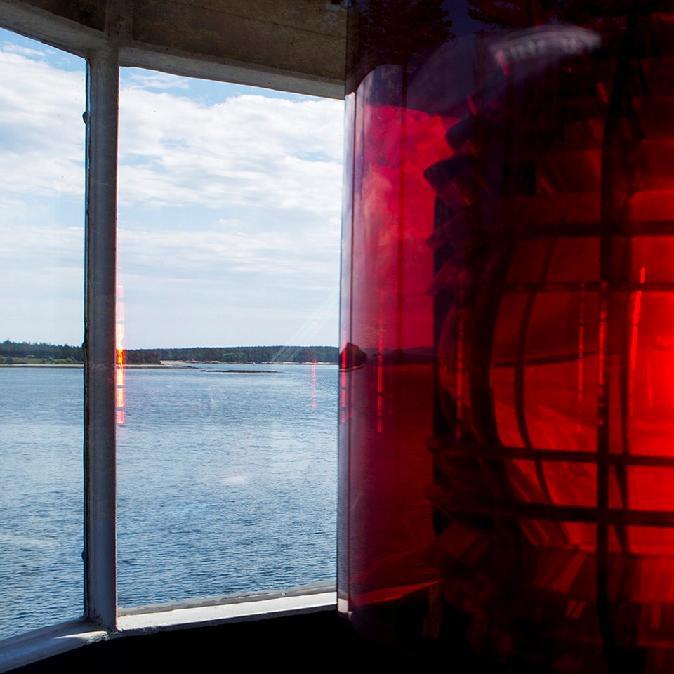 Lighthouse tower with red cone around light