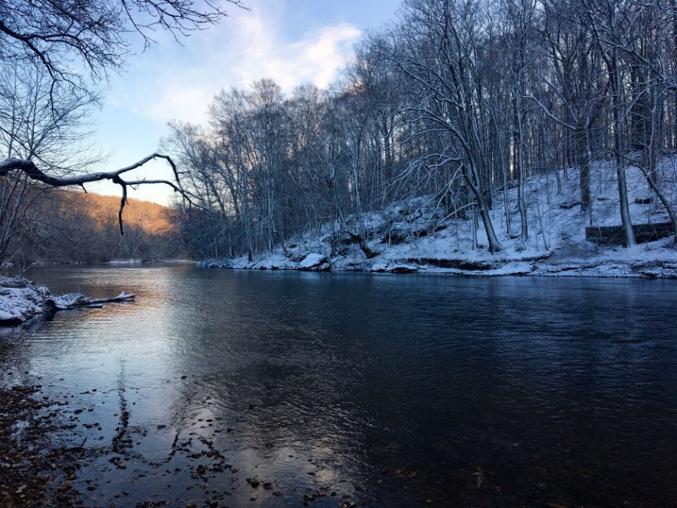 A person in a kayak travels down the Brandywine Creek on a mid fall day.