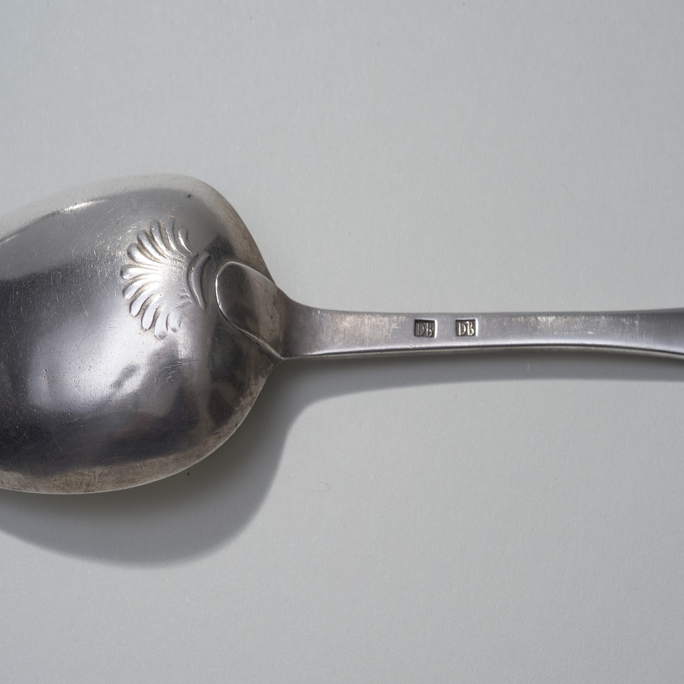 A close up of one of Duncan Beard's silver spoons showing his mark.