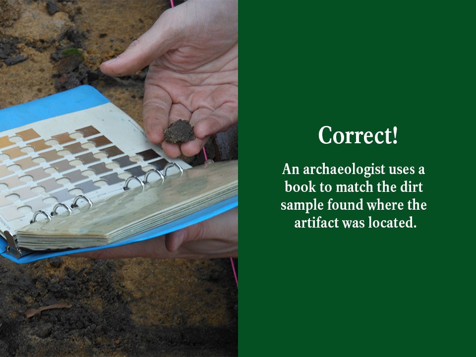 An archaeologist uses a book to match the dirt sample found where the artifact was located.