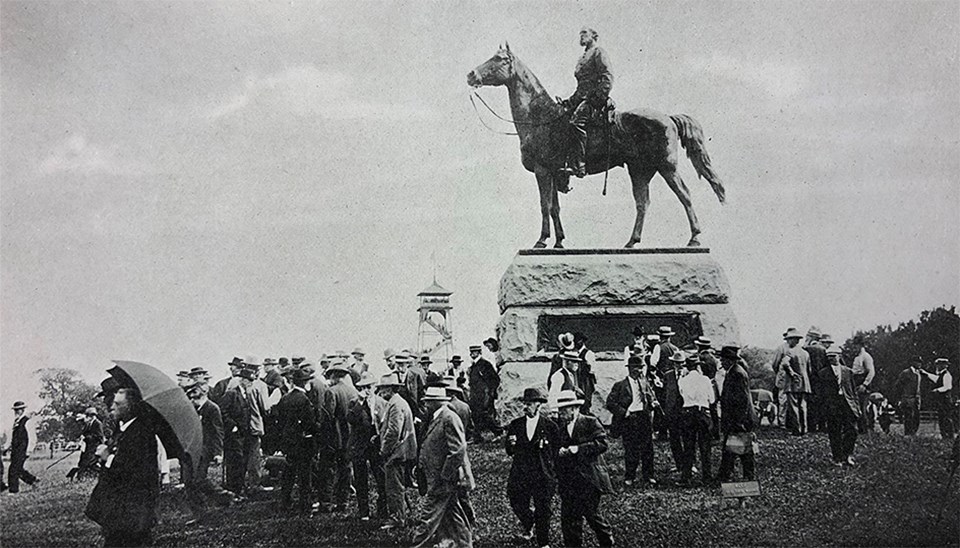 Civil War veterans gather around the large equestrian statue of General George Gordon Meade.