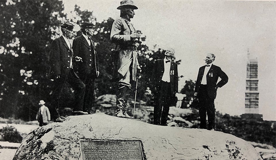 A group of Civil War veterans visit the statue to General Gouverneur Kemble Warren at the summit of Little Round Top.
