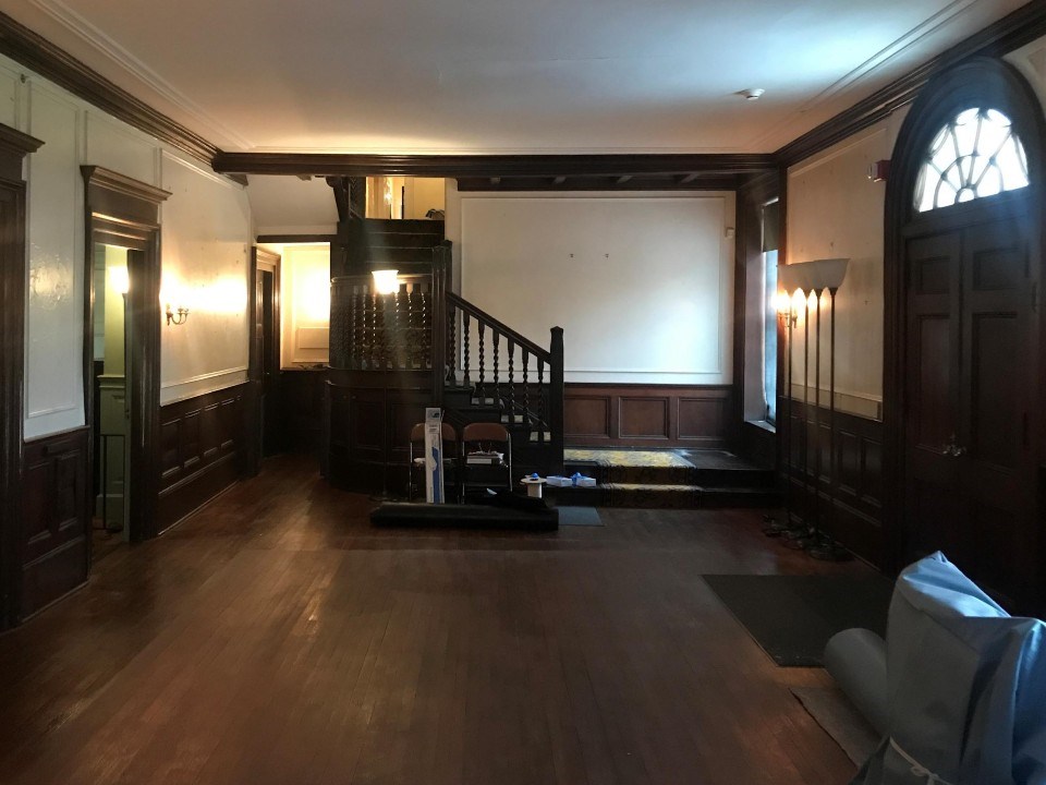 A furnished room with staircase.