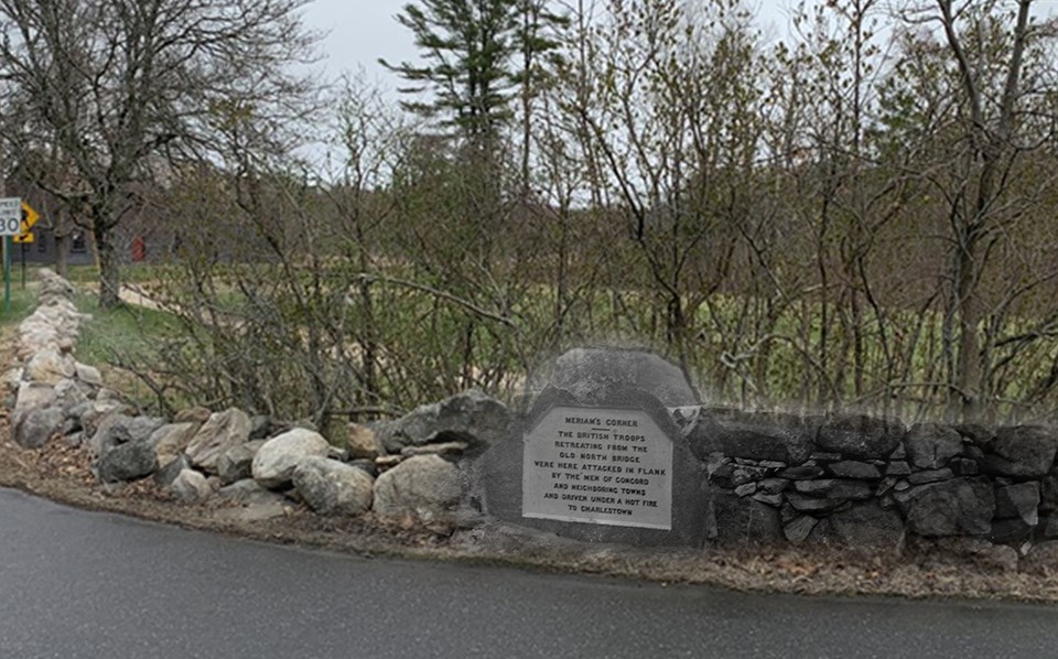 A stone monument set into a crumbling stone wall. Bushes and tress obscure an open field behind