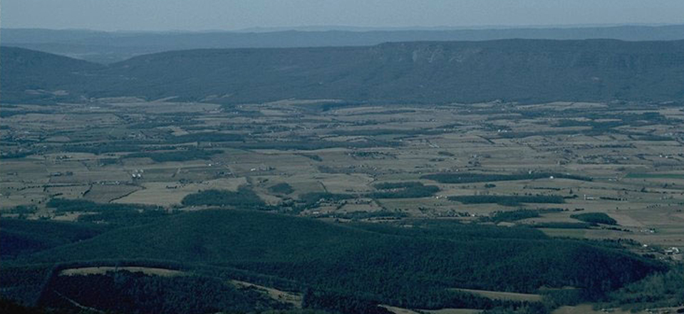 A photograph looking out towards New Market Gap from Skyland, blanketed in haze.