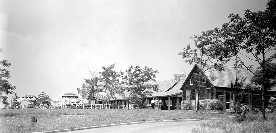 A black and white photograph of a rustic building.
