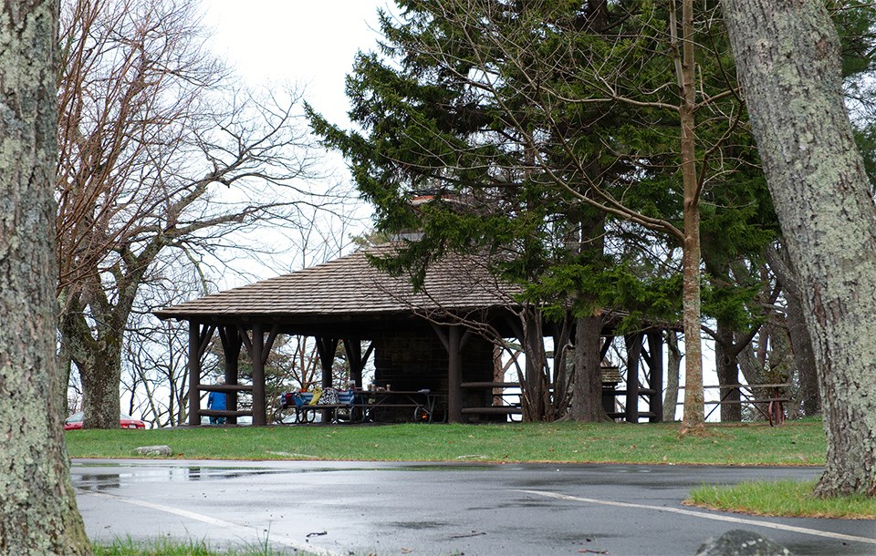 A black and white photograph of a picnic shelter.