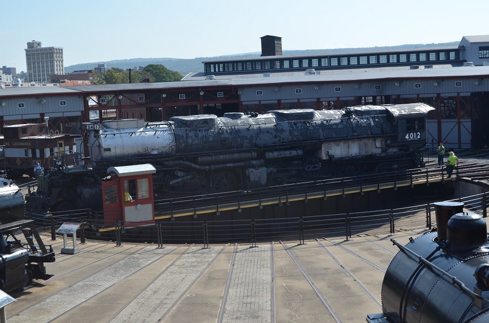 Elevated viewpoint of large and rusty train with front facing left