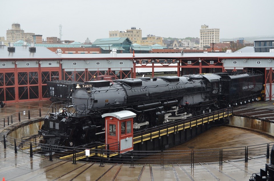 Elevated viewpoint of large and rusty train with front facing left