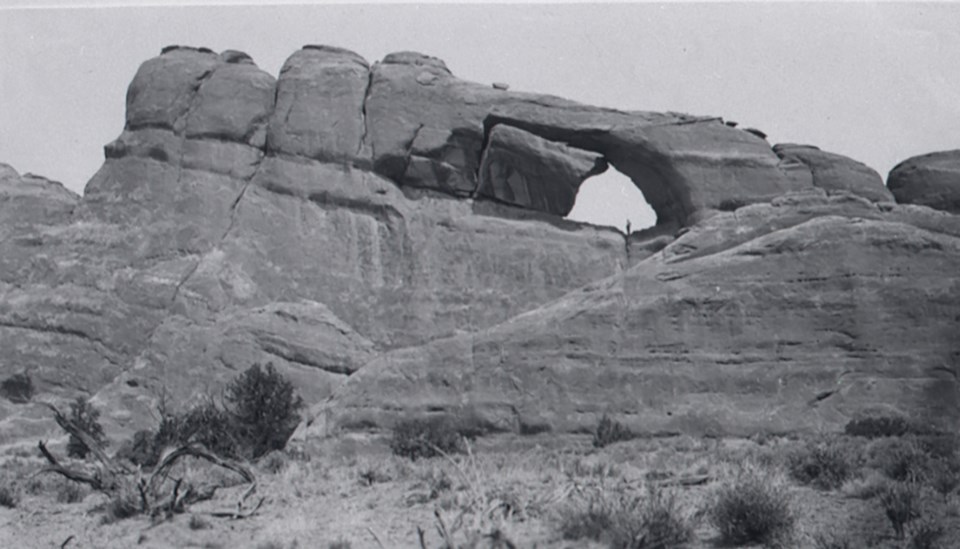an arch with a large boulder on one side