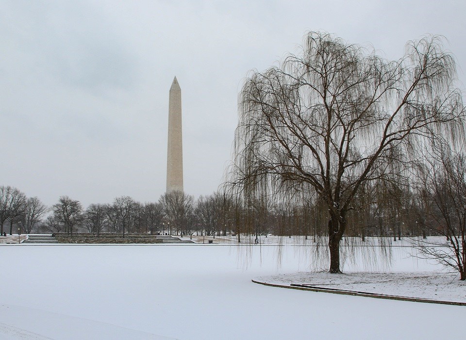 Washington Monument behind a snow-covered lake