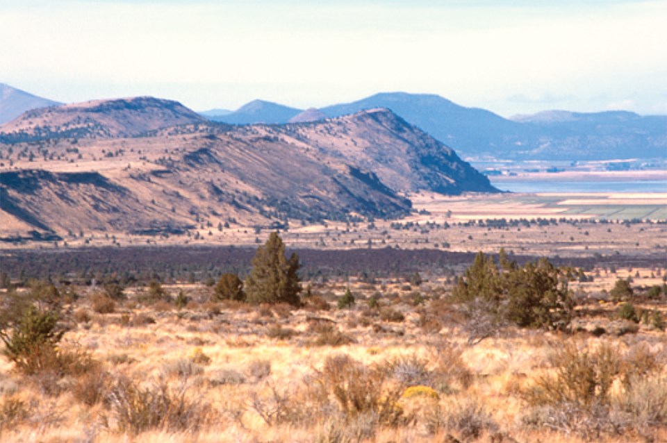 arid landscape with hills, scarp, and basin