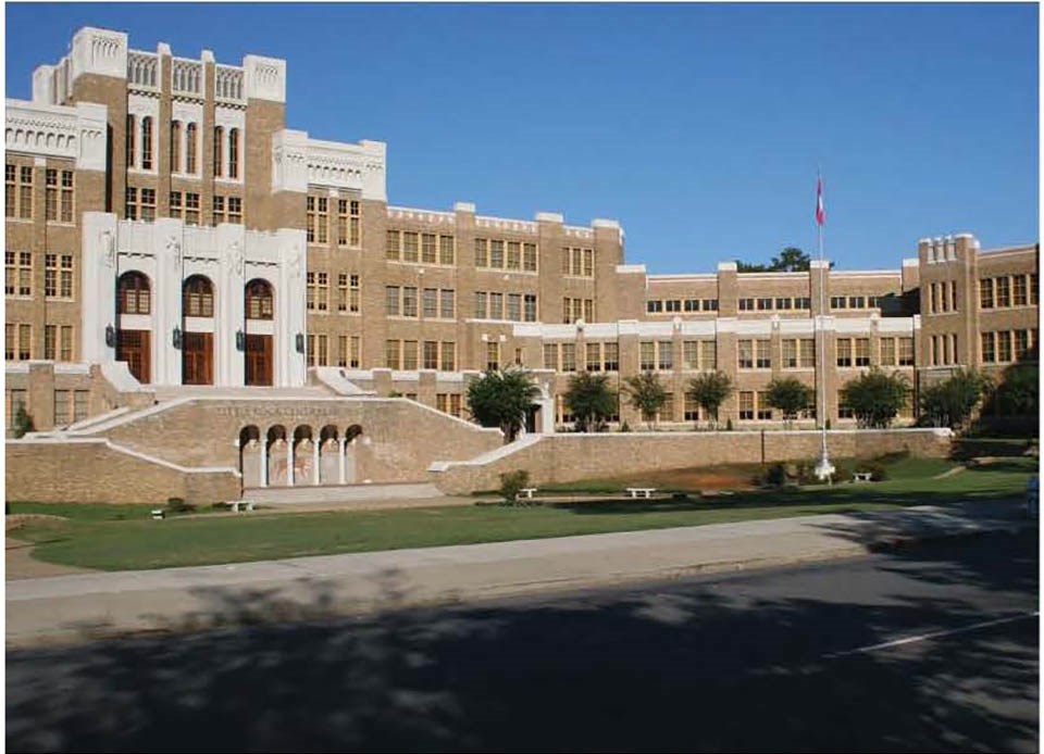 National Guard troops in military jeeps parked on the street in front of the entrance to Central High School