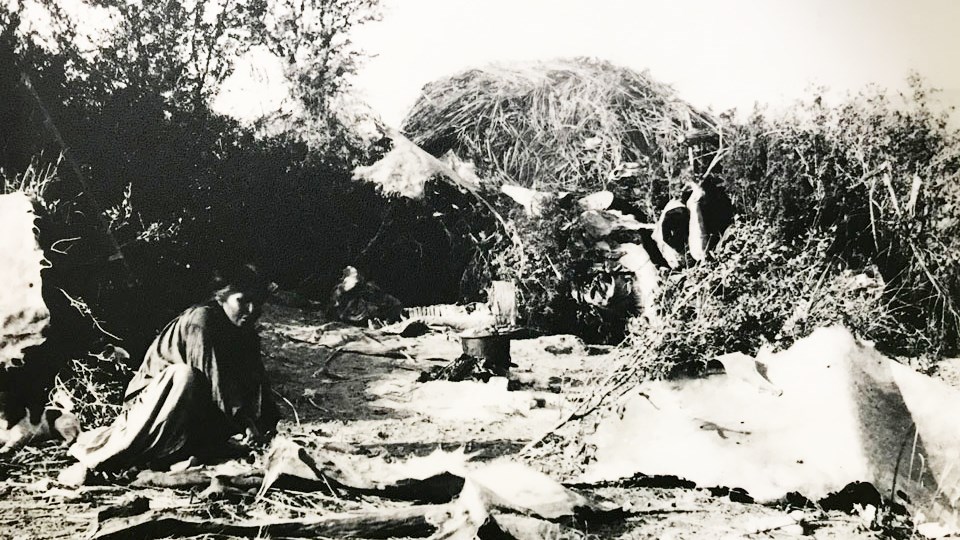 black and white image of woman in apache village