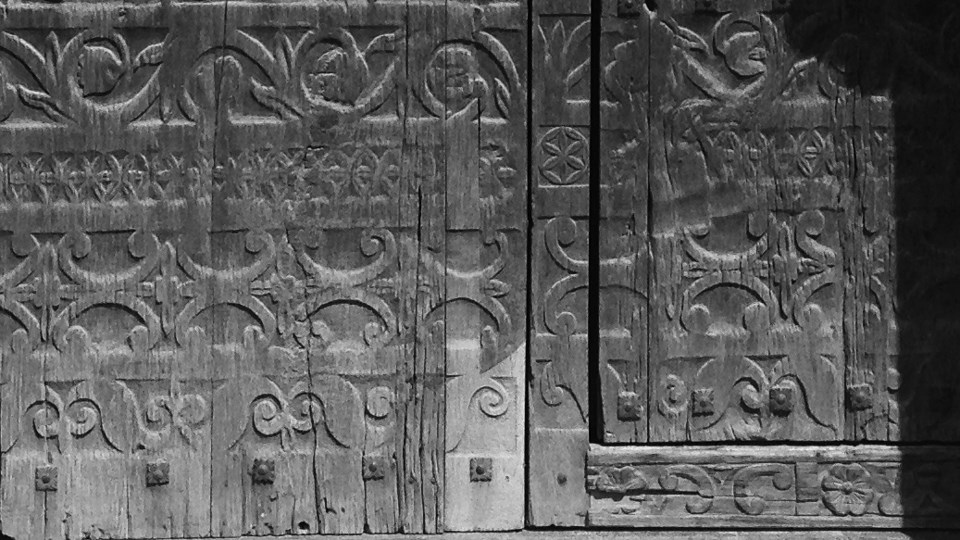 historic photo of ornate carved wooden doors