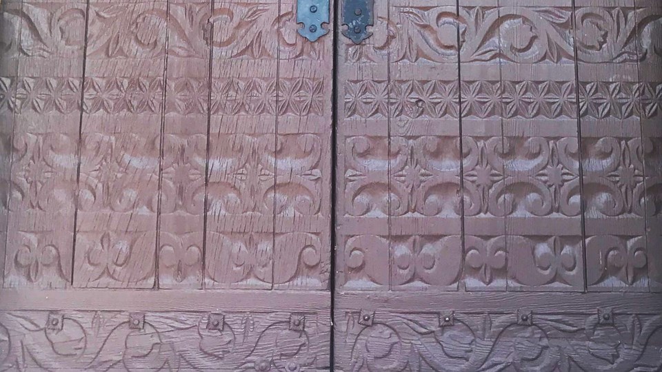 historic photo of ornate carved wooden doors