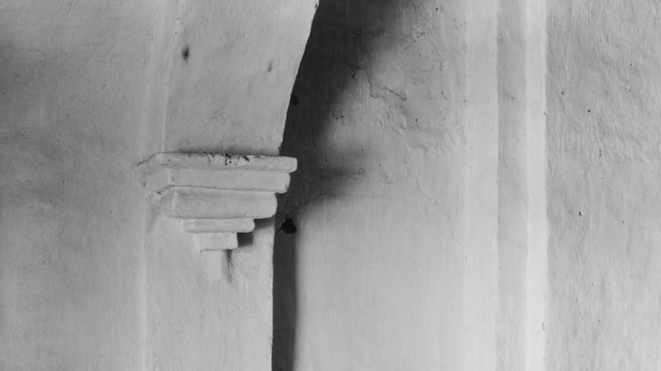 historic photo of corbel on base of arch